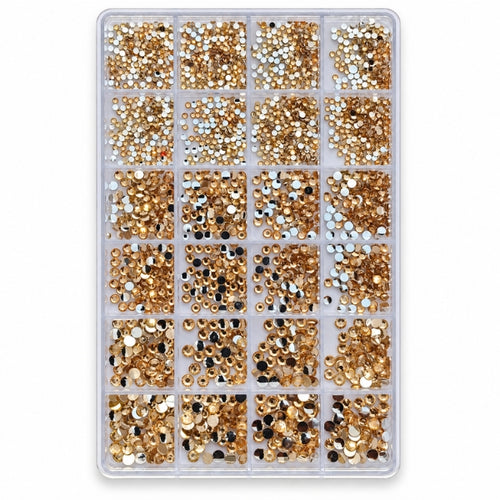 A clear plastic organizer tray filled with many small round rhinestones or gems in metallic gold, silver, and black, arranged in a grid on a white background. FOR NAIL ART USE