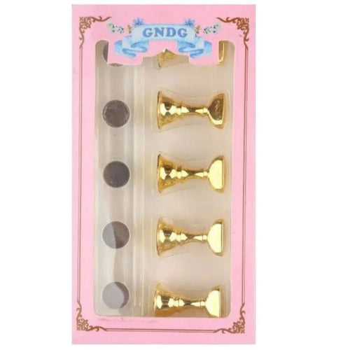 GNDG magnetic nail tip stand with gold-tone pedestal holders and a clear rectangular base in pink packaging.