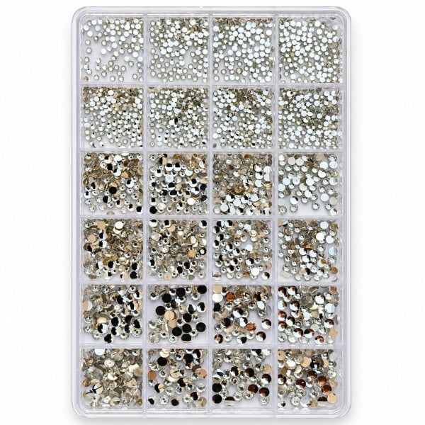 A clear plastic organizer tray filled with many small round rhinestones and sequins in assorted metallic and dark colors, arranged in a grid of compartments on a white background.