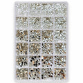 A clear plastic organizer tray filled with many small round rhinestones and sequins in assorted metallic and dark colors, arranged in a grid of compartments on a white background.