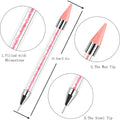 Rhinestone picker pen with a pink wax tip, fine steel tip and a clear handle filled with pink decorative crystals.