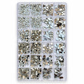 A clear plastic organizer tray filled with assorted rhinestone and metallic nail art embellishments in silver, white, and champagne tones, photographed on a plain white background. FOR NAIL ART USE