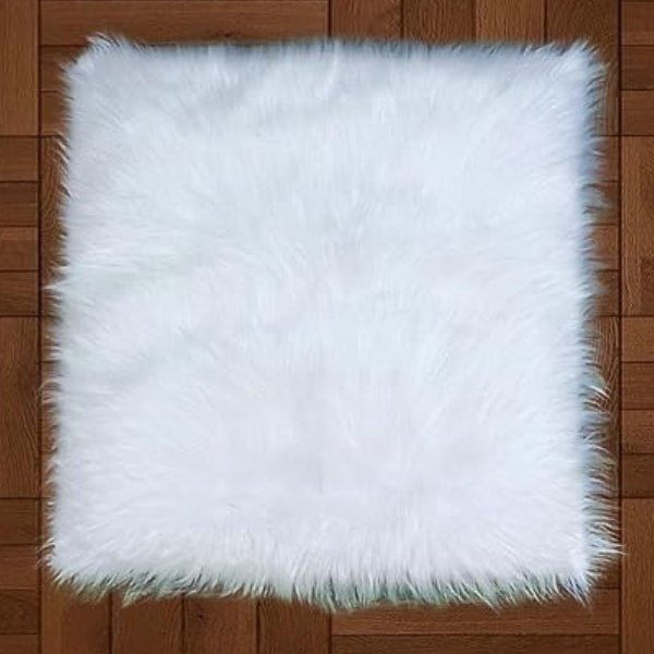 White fluffy mat with a square shape, dense long fibres and shaggy edges, laid flat for nail art display.